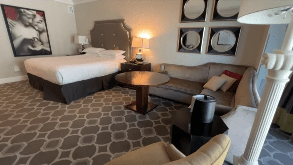 What It’s Like Staying at Caesars Palace Las Vegas - Still Cool? 19 Caesars Palace Las Vegas review Luxurious King Pool View room in the Octavius Tower, featuring a comfortable bed, L-shaped couch, and marble bathroom.